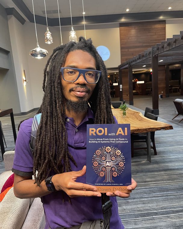 Reader holding a pre-sale copy of ROI with AI